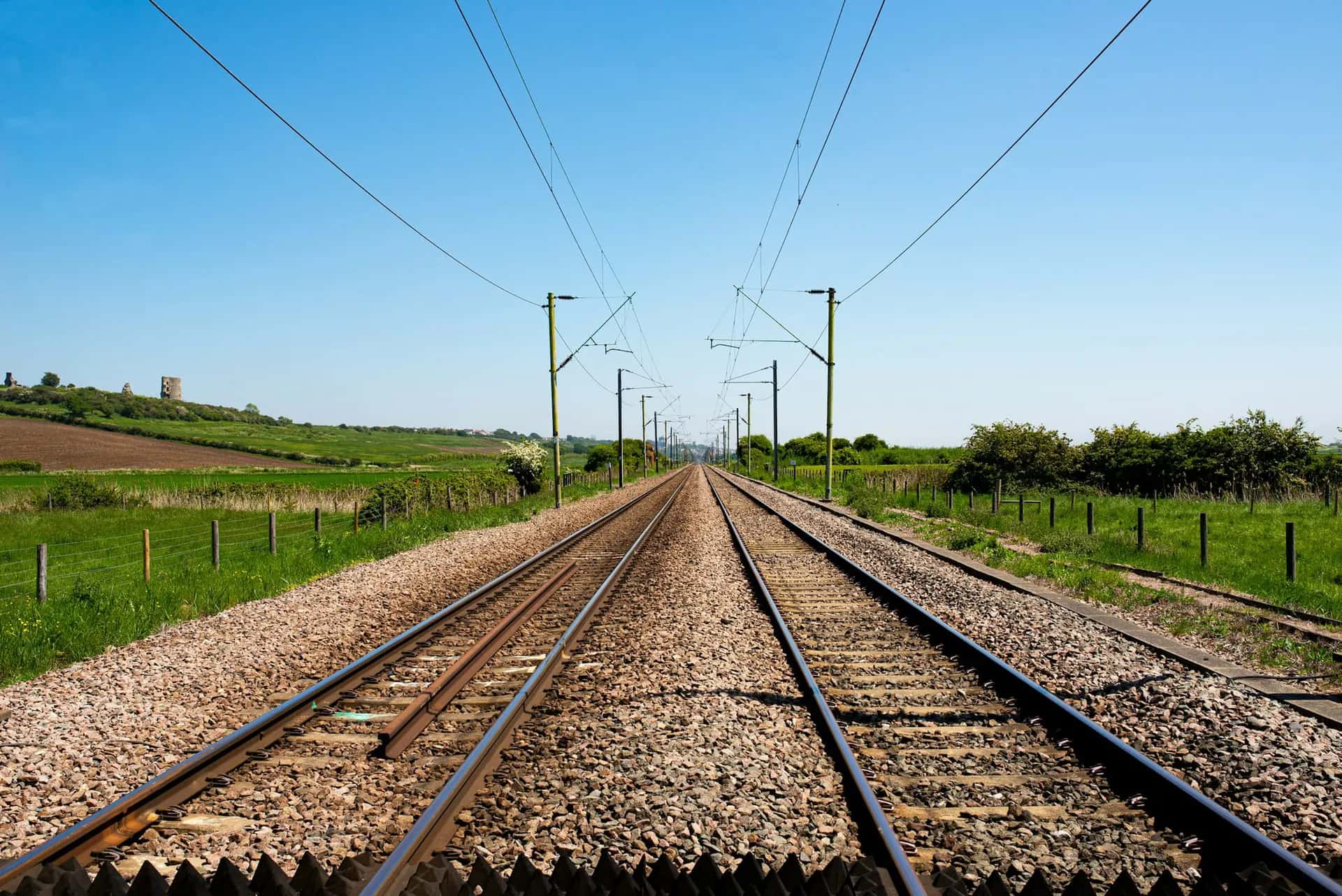 Steel railway rails stretching into the distance