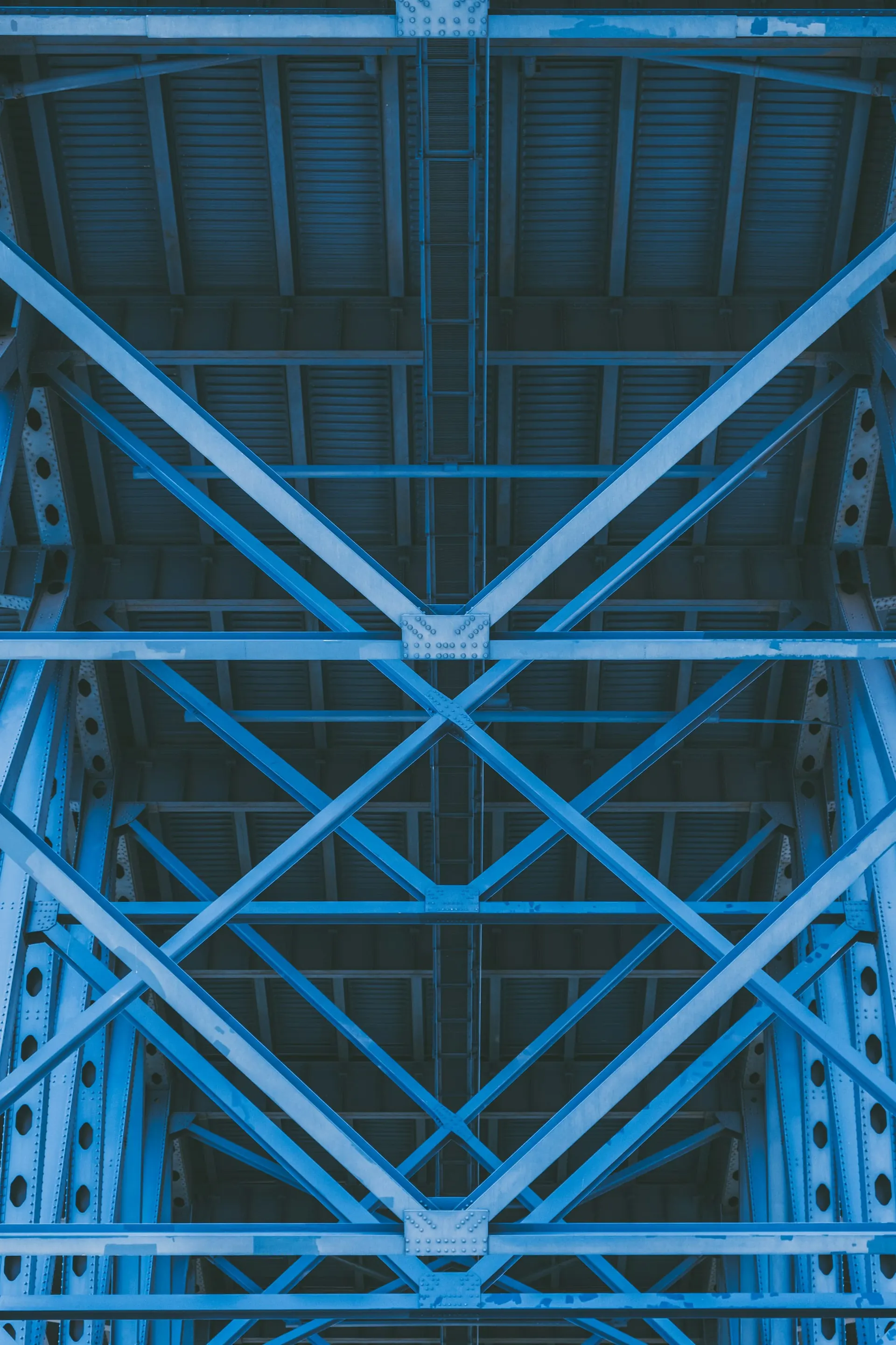 Painted steel truss framework seen from below