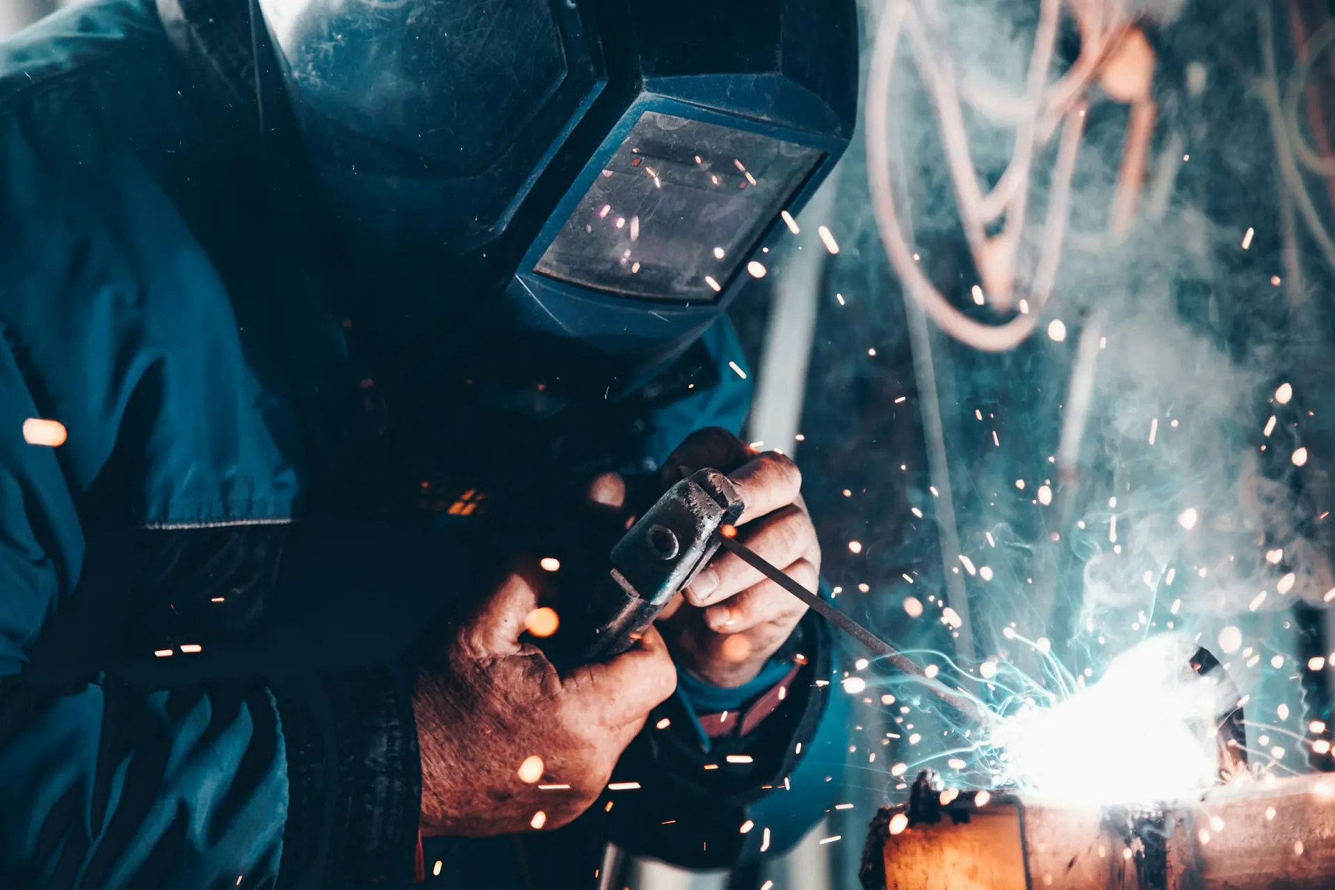 Welder working on steel with sparks